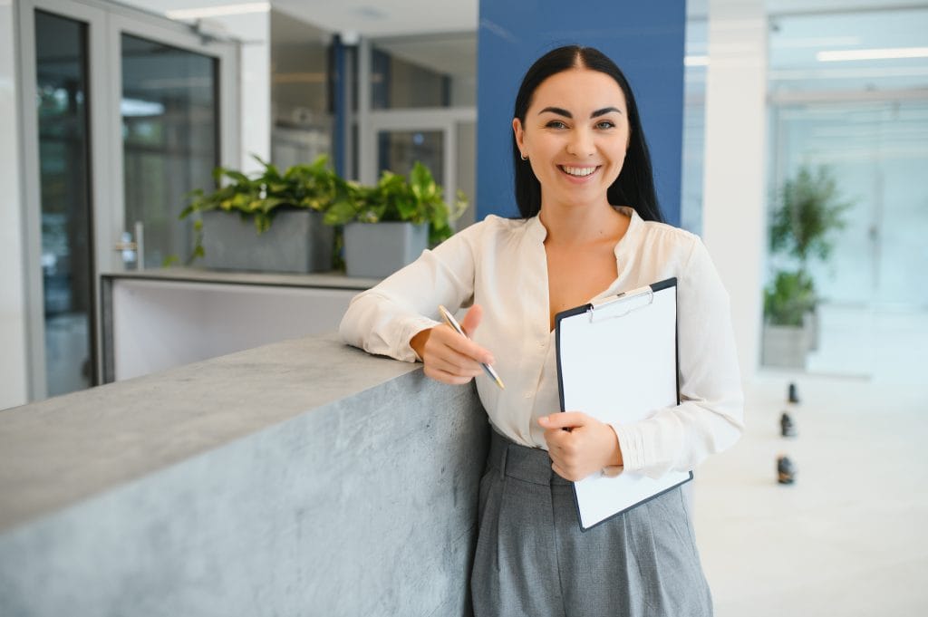 Home 1 portrait beautiful receptionist near counter hotel
